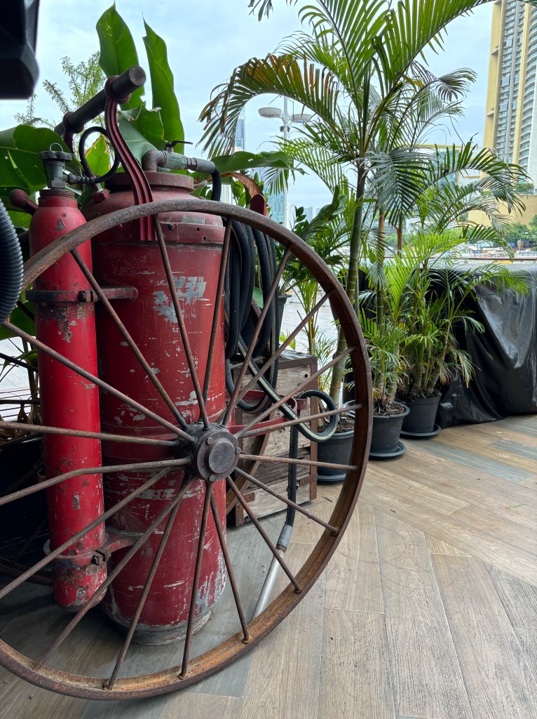 Giant fire extinguisher on a tropical riverside 