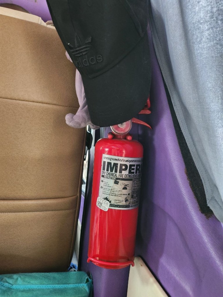 Mini extinguisher with a black cap on a karaoke van